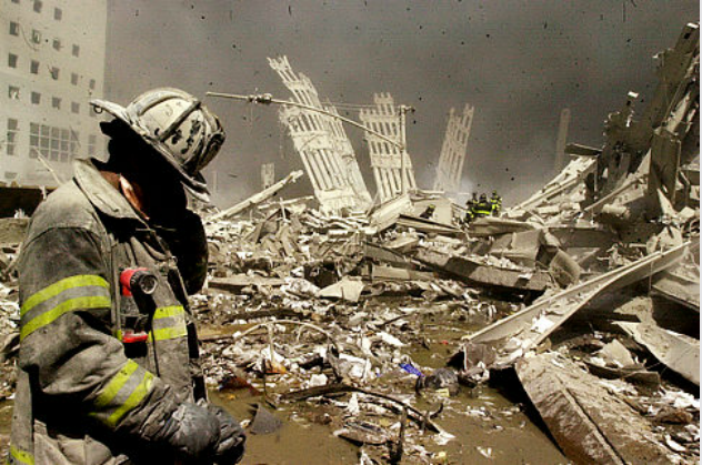 Firefighter walks through the rubble of the World Trade Center
